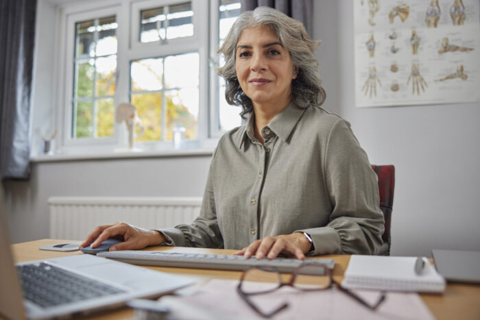 Female GP at desk Woman GP at desk